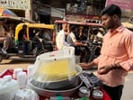 The vendor stands motionless behind a giant platter of daulat ki chaat. (Mayank Austen Soofi)