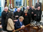 President Donald Trump praying at Oval Office with archbishops and bishops.