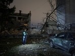 A resident walks at the site of a food production facility hit by a Russian missile strike, amid Russia's attack on Ukraine, in Kyiv.