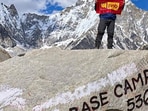 Pradeep Mundeja hoists a flag at Everest Base Camp in Nepal.