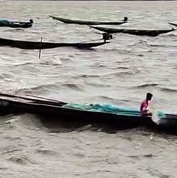 A Fisherman sails his boat amid high tidal waves hitting the coast under the influence of Cyclone Arnab, in Puri on Thursday.