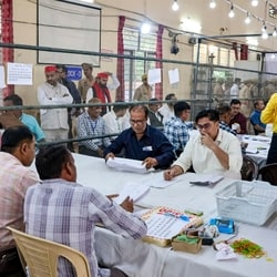 Divisional Commissioner Bhanu Chandra Goswami along with officials count postal ballots for the Uttar Pradesh Legislative Council (MLC) Graduate and Teacher constituency elections, at a counting centre, in Meerut.