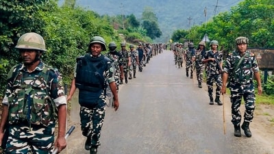 Arunachal Pradesh Police and CRPF personnel conduct a flag march amid tensions over the proposed Siang Multipurpose Hydroelectric Project, at Geku, in Upper Siang district, (PTI)