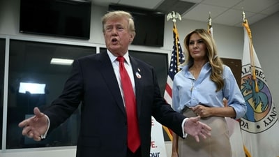 TOPSHOT - US President Donald Trump and First Lady Melania Trump speak to the press at the Palm Beach County Supervisor of Elections office after voting in the midterm elections in West Palm Beach, Florida, on October 24. (Photo by Brendan SMIALOWSKI / AFP) TOPSHOT - US President Donald Trump and First Lady Melania Trump speak to the press at the Palm Beach County Supervisor of Elections office after voting in the midterm elections in West Palm Beach, Florida, on October 24. (Photo by Brendan SMIALOWSKI / AFP)