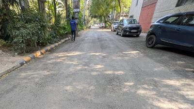The roads in blocks I to Q were taken up for recarpeting around October 8. During a spot check on Tuesday, HT found loose gravel, uneven patches and stones scattered across stretches, with dust accumulating on the surface. (HT Photo)