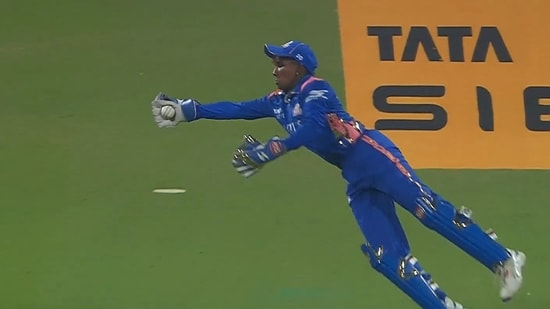 File image of wicket-keeper batter G Kamalini taking a one-handed catch in WPL.