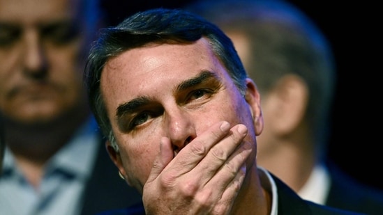 Flávio Bolsonaro faces mounting legal pressure after refusing to concede defeat, while authorities remain uncertain about his whereabouts. (Photo by Evaristo Sa / AFP)