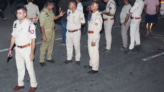 Police personnel at the site after five people were allegedly shot dead.
