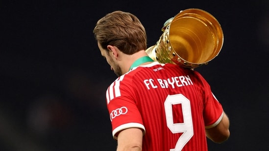 Bayern Munich's Harry Kane carries the trophy as he celebrates winning the DFB Cup 