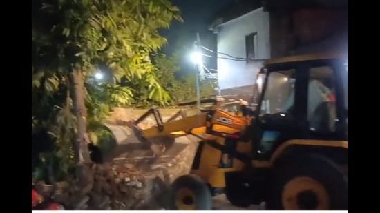 The boundary wall of the accused’s premises being demolished by the LDA on Tuesday night. (Sourced)