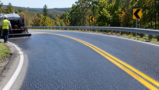Representative image of a winding roadway treated with a high-friction surface to improve tire grip and reduce wet-weather crashes.