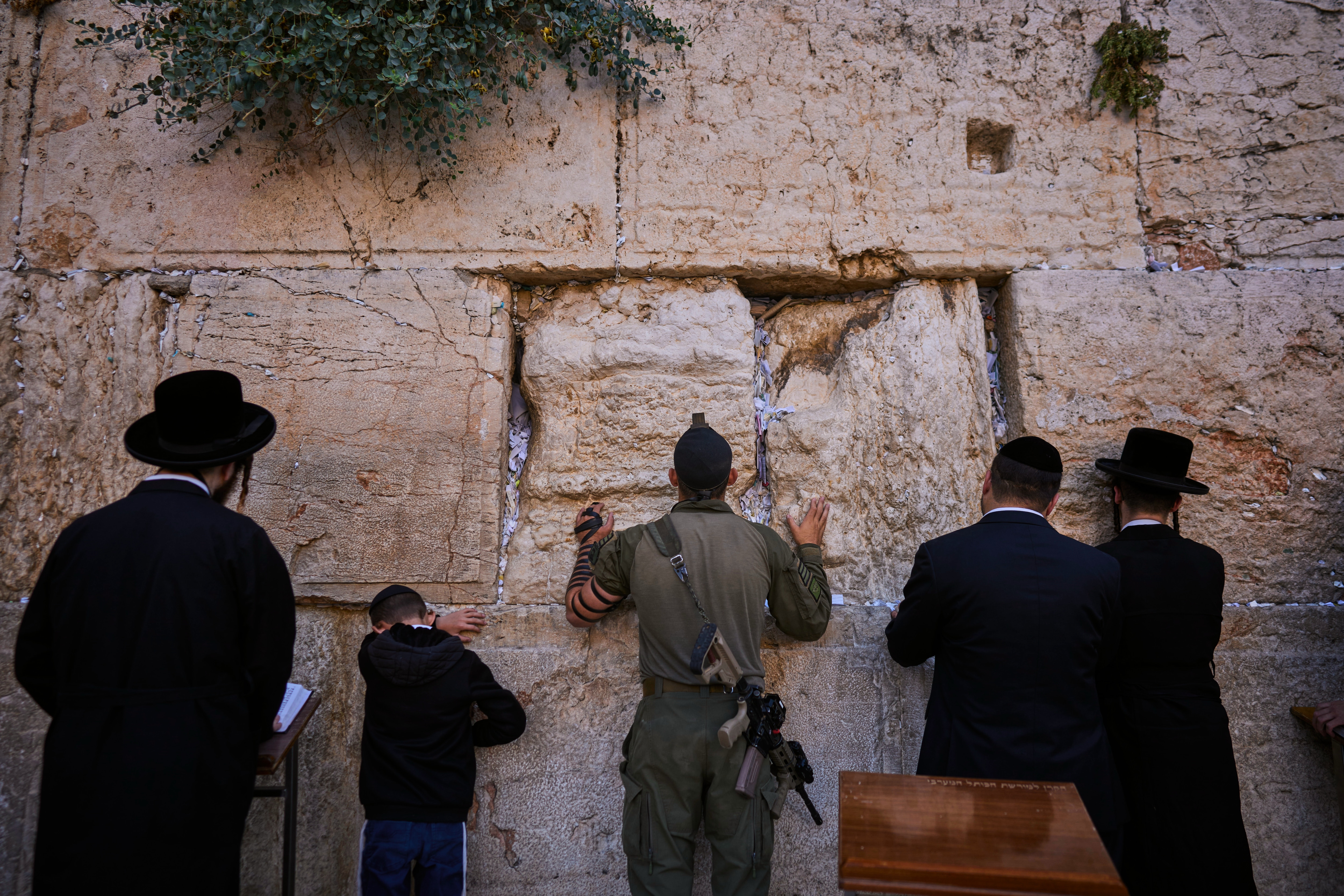 Ultra-Orthodox Jewish worshippers pray beside a soldier from the Haredi Hashmonaim Brigade at the Western Wall in Jerusalem's Old City, Thursday, Aug. 6, 2026. (AP Photo/Ohad Zwigenberg) (AP Photo/Ohad Zwigenberg) Ultra-Orthodox Jewish worshippers pray beside a soldier from the Haredi Hashmonaim Brigade at the Western Wall in Jerusalem's Old City, Thursday, Aug. 6, 2026. (AP Photo/Ohad Zwigenberg) (AP Photo/Ohad Zwigenberg)