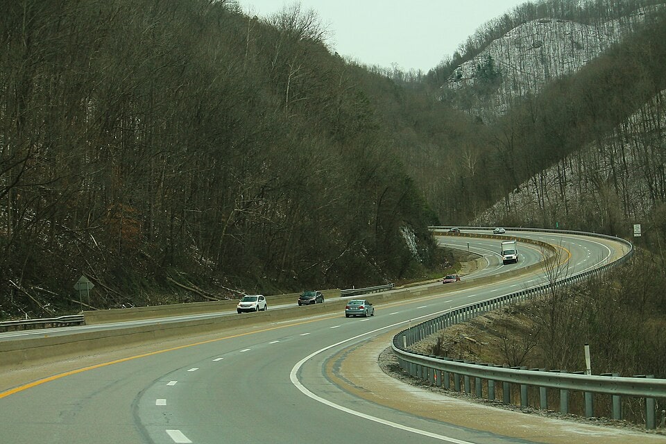 A curving section of the West Virginia Turnpike, illustrating the type of roadway locations targeted by high-friction surface treatments to reduce wet-road and overall crashes. (Wikimedia Commons.) A curving section of the West Virginia Turnpike, illustrating the type of roadway locations targeted by high-friction surface treatments to reduce wet-road and overall crashes. (Wikimedia Commons.)