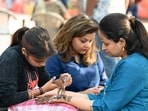 Gram it: Karwa Chauth vibes have taken over the city today as women have been seen shopping for festive bangles and jewellery. Here's a shopper who paused to get mehendi applied on her hands, near Hanuman Temple in Connaught Place, on Tuesday.