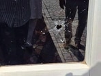 A glass door bearing a bullet mark. (HT)