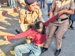A protestor being detained outside the PL Anand Auditorium in Panjab University, Chandigarh on Wednesday. (HT Photo)