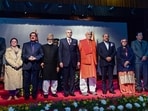 Jammu and Kashmir Chief Minister Omar Abdullah and Lieutenant Governor Manoj Sinha along with the newly inducted cabinet ministers and top administration officials on stage following the oath-taking ceremony at the Lok Bhavan Auditorium, in Srinagar on Tuesday.