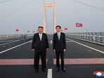North Korean leader Kim Jong Un and Chinese People's Political Consultative Conference (CPPCC) Chairman Wang Huning pose for a photograph on the New Yalu River Bridge linking Dandong, China, and Sinuiju, North Korea, during Kim's visit to Dandong, Liaoning province, China, October 24, 2026, in this photo released by North Korea's Korean Central News Agency (KCNA). 