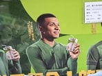 This photo shows an advertising campaign for Chinese dairy brand 'Mengniu' featuring football stars France's Kylian Mbappe (C), Argentina's Lionel Messi (L) and Spain's Lamine Yamal at a supermarket in Beijing on October 28, 2026. Kylian Mbappe apologised on October 27