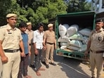 Gurugram police with the seized contraband. (HT Photo)