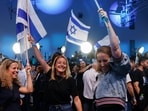 Supporters of former military chief Gadi Eisenkot, leader of the Yashar party, react following national election exit polls at his party headquarters in Tel Aviv, Israel.