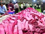 Polling officials handle ballot papers during the counting of votes. 