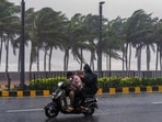 Visakhapatnam: Commuters wade ahead of the impending landfall of cyclonic storm 'Arnab'.(PTI)