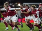 Fleetwood Town players celebrate winning the penalty shootout.