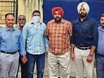 The accused (with his face covered) in the custody of VB officials in Ludhiana on Wednesday. (HT Photo)