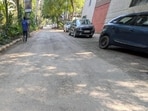 The roads in blocks I to Q were taken up for recarpeting around October 8. During a spot check on Tuesday, HT found loose gravel, uneven patches and stones scattered across stretches, with dust accumulating on the surface. (HT Photo)