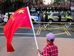A supporter of the Chinese Communist Party (CCP) waves a Chinese flag as pro-Tibet demonstrators rally across the street in Washington, D.C. on September 24, 2026.
