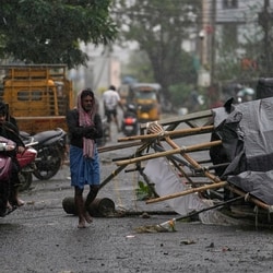 Severe cyclonic storm Arnab LIVE updates: A man walks past the destruction caused in Kakinada, India, after Cyclone Arnab crossed the Andhra Pradesh coast.