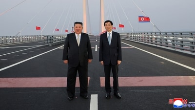 North Korean leader Kim Jong Un and Chinese People's Political Consultative Conference (CPPCC) Chairman Wang Huning pose for a photograph on the New Yalu River Bridge linking Dandong, China, and Sinuiju, North Korea, during Kim's visit to Dandong, Liaoning province, China, October 24, 2026, in this photo released by North Korea's Korean Central News Agency (KCNA). North Korean leader Kim Jong Un and Chinese People's Political Consultative Conference (CPPCC) Chairman Wang Huning pose for a photograph on the New Yalu River Bridge linking Dandong, China, and Sinuiju, North Korea, during Kim's visit to Dandong, Liaoning province, China, October 24, 2026, in this photo released by North Korea's Korean Central News Agency (KCNA).