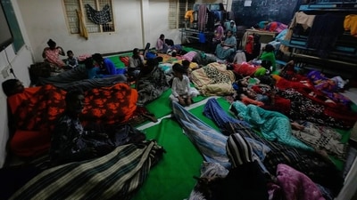 People gather at a temporary shelter set up inside a school as Cyclone Arnab approaches the Andhra Pradesh coast in Kakinada, India. (AP Photo/Mahesh Kumar A.)
