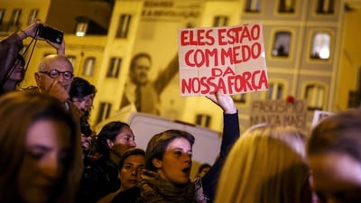 A woman holds a sign reading "They are afraid of our strength" during a protest against the housing shortage, soaring rents and low wages in front of the Portuguese Parliament in Lisbon. (AFP) A woman holds a sign reading "They are afraid of our strength" during a protest against the housing shortage, soaring rents and low wages in front of the Portuguese Parliament in Lisbon. (AFP)