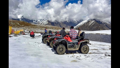 Tourists sit on all-terrain vehicles (ATVs) parked on snow-covered ground following fresh snowfall at Rohtang Pass, in Kullu district, Himachal Pradesh, Friday. (PTI File) Tourists sit on all-terrain vehicles (ATVs) parked on snow-covered ground following fresh snowfall at Rohtang Pass, in Kullu district, Himachal Pradesh, Friday. (PTI File)