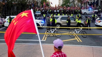 A supporter of the Chinese Communist Party (CCP) waves a Chinese flag as pro-Tibet demonstrators rally across the street in Washington, D.C. on September 24, 2026. (REUTERS)