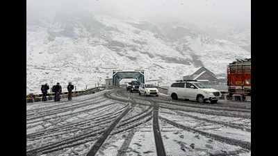 Vehicles ply on a snow-covered road near the North Portal of the Atal Tunnel amid fresh snowfall, in Lahaul and Spiti district, Himachal Pradesh. (PTI File)