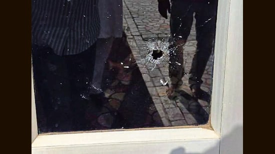 A glass door bearing a bullet mark. (HT)