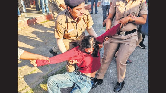A protestor being detained outside the PL Anand Auditorium in Panjab University, Chandigarh on Wednesday. (HT Photo)