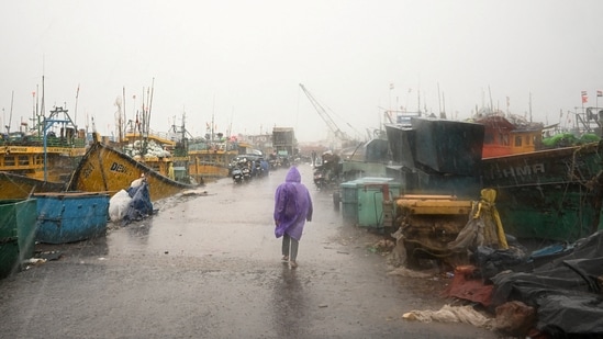 Cyclone Arnab landfall news LIVE: A man walks past docked boats along the harbour amid rain and gusty winds as Cyclone Arnab approaches in Visakhapatnam, Andhra Pradesh.