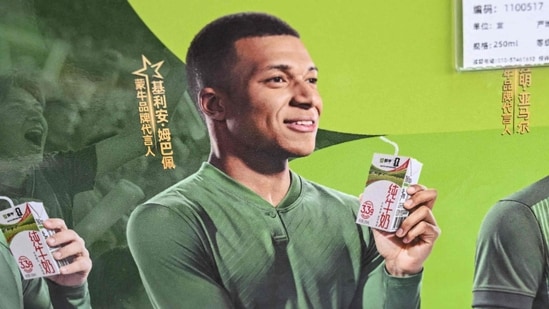 This photo shows an advertising campaign for Chinese dairy brand 'Mengniu' featuring football stars France's Kylian Mbappe (C), Argentina's Lionel Messi (L) and Spain's Lamine Yamal at a supermarket in Beijing on October 28, 2026. Kylian Mbappe apologised on October 27 (AFP)