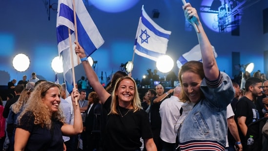 Supporters of former military chief Gadi Eisenkot, leader of the Yashar party, react following national election exit polls at his party headquarters in Tel Aviv, Israel.