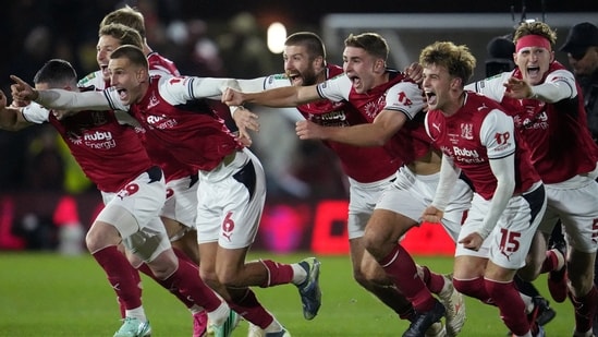 Fleetwood Town players celebrate winning the penalty shootout.