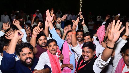 Samajwadi Party workers and supporters celebrate in Lucknow on Wednesday. (HT PHOTO)