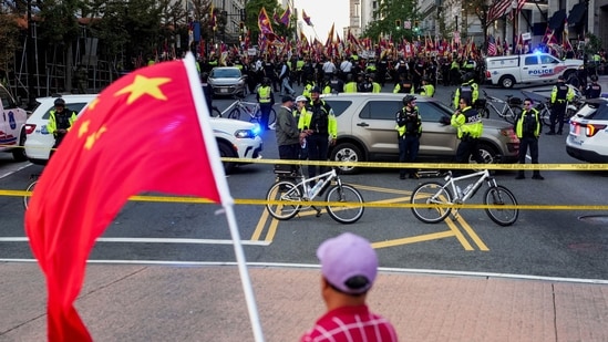 A supporter of the Chinese Communist Party (CCP) waves a Chinese flag as pro-Tibet demonstrators rally across the street in Washington, D.C. on September 24, 2026.