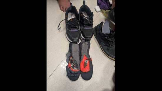 officials became suspicious after noticing that the black sports shoes he was wearing had unusually thick soles and appeared heavier than normal. (HT)