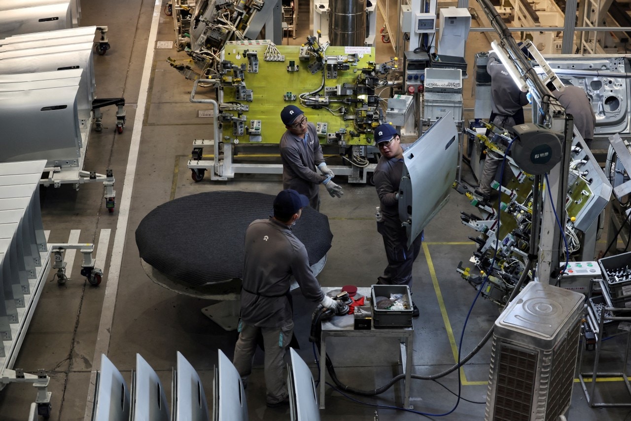 Workers on the production line of EV maker Nio in Hefei in 2025. Workers on the production line of EV maker Nio in Hefei in 2025.