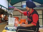 A dairy owner pouring milk into a container in Ludhiana on Thursday. (Gurpreet Singh/HT)