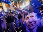 Supporters of Israeli Prime Minister Benjamin Netanyahu celebrate at Likud party headquarters in Jerusalem following the release of the first exit poll results in Israel's general election Wednesday, Oct. 28, 2026.